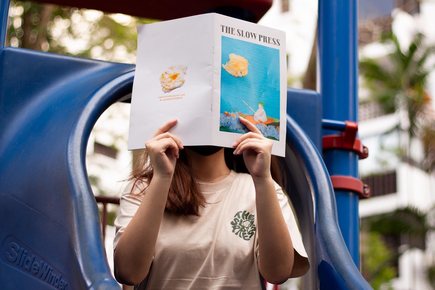 Model holding a copy of volume 1.