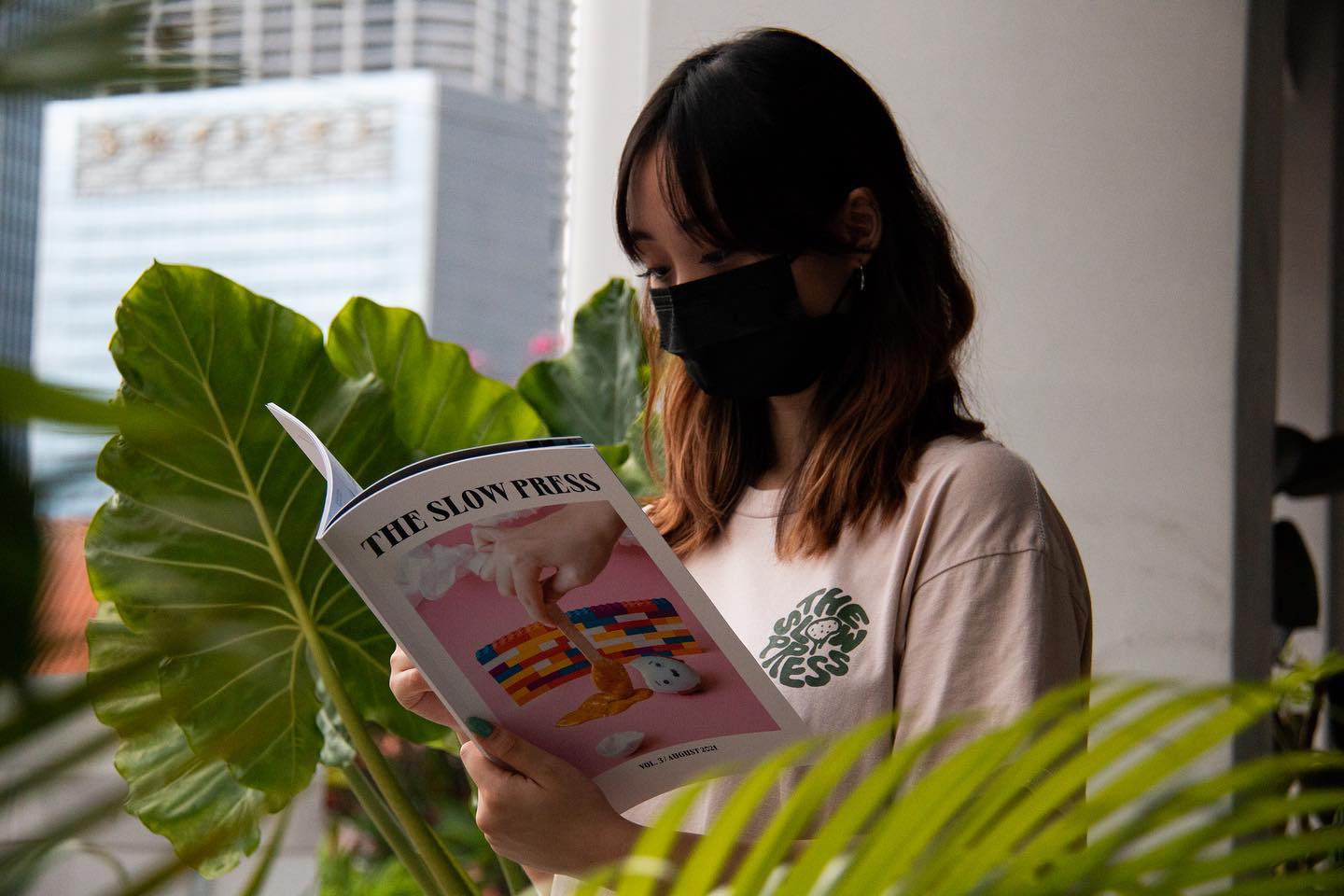 Model holding a copy of volume 3.